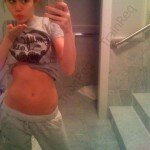 Miley Cyrus Stripping to Expose her Belly on Camera