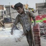 Photo of a Child Carrying Heavy Load in Bangladesh