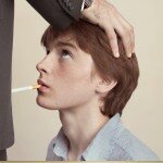 French Anti-Smoking Campaign Ad Picture with a Child Giving Cigarette Blowjob to a Tobacco Exec